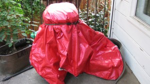 Covered indigo dye pot.