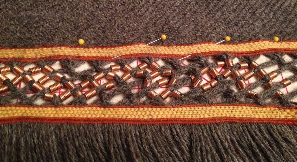 Border with interlaced fingerloop braiding with coils, horribly distorted and wrong.  So very wrong.